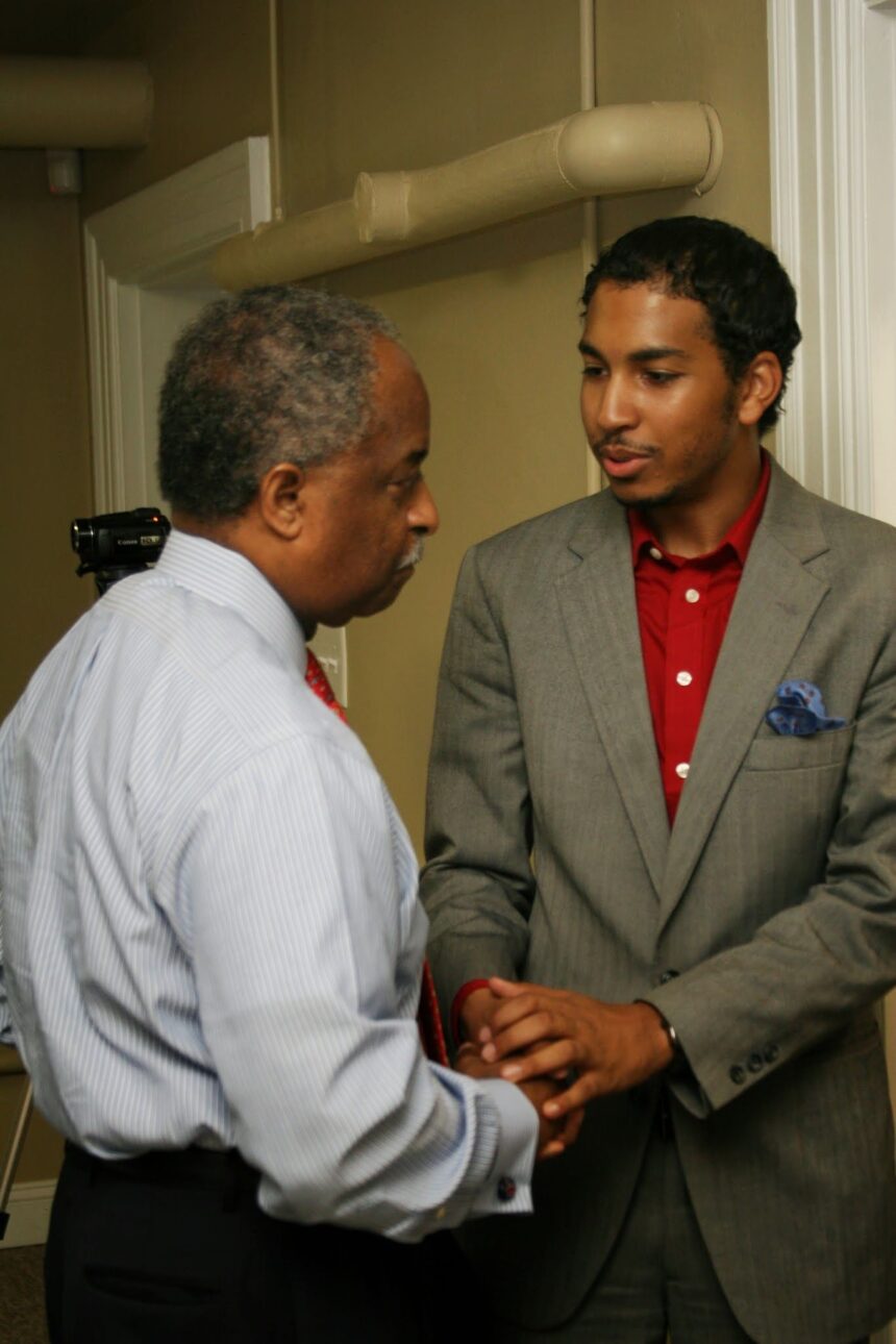 Courtney Jordan and Mayor William V. "Bill" Bell shaking hands at a community event.