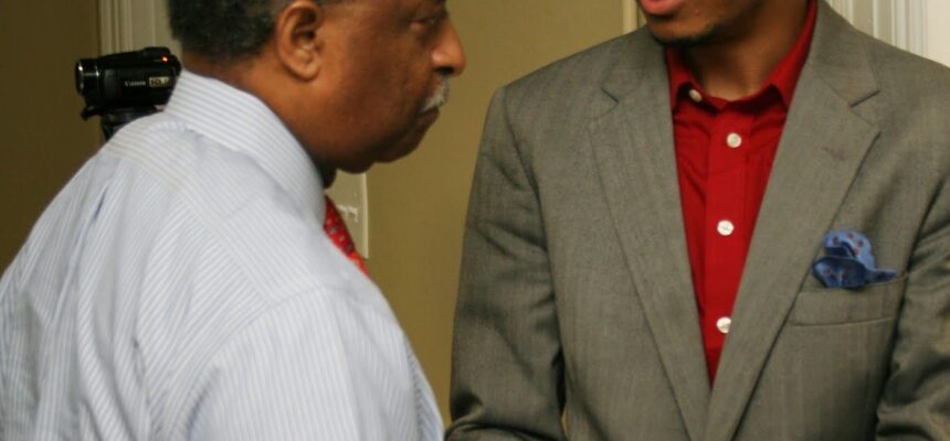 Courtney Jordan and Mayor William V. "Bill" Bell shaking hands at a community event.