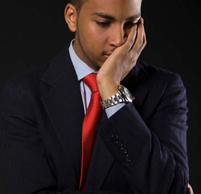 Courtney Jordan, entrepreneur and philanthropist, deep in thought with his head bowed and hands clasped, reflecting on his next steps.