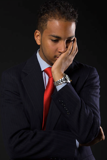 Courtney Jordan, entrepreneur and philanthropist, deep in thought with his head bowed and hands clasped, reflecting on his next steps.